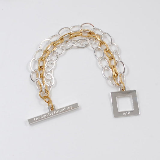 designat armband i två färger guld silver kedjor design by brandeby