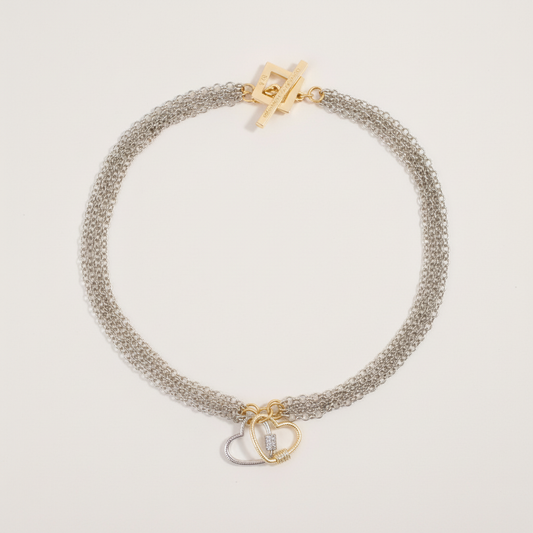 Handgjort halsband med avtagbara hjärtan och flexibel design. Tillverkat i rostfritt stål med 18K guld PVD-behandlat lås. Mycket begränsad upplaga från Design by Brandeby.