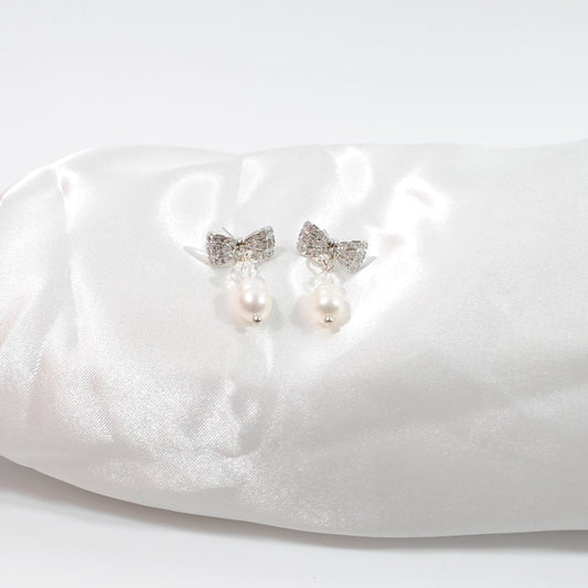 Eleganta Bow Pearls Silver Örhängen i silver med strass fylld rosett, äkta sötvattenpärla och bergkristall. Handgjorda i Sverige. Limited edition. handgjorda