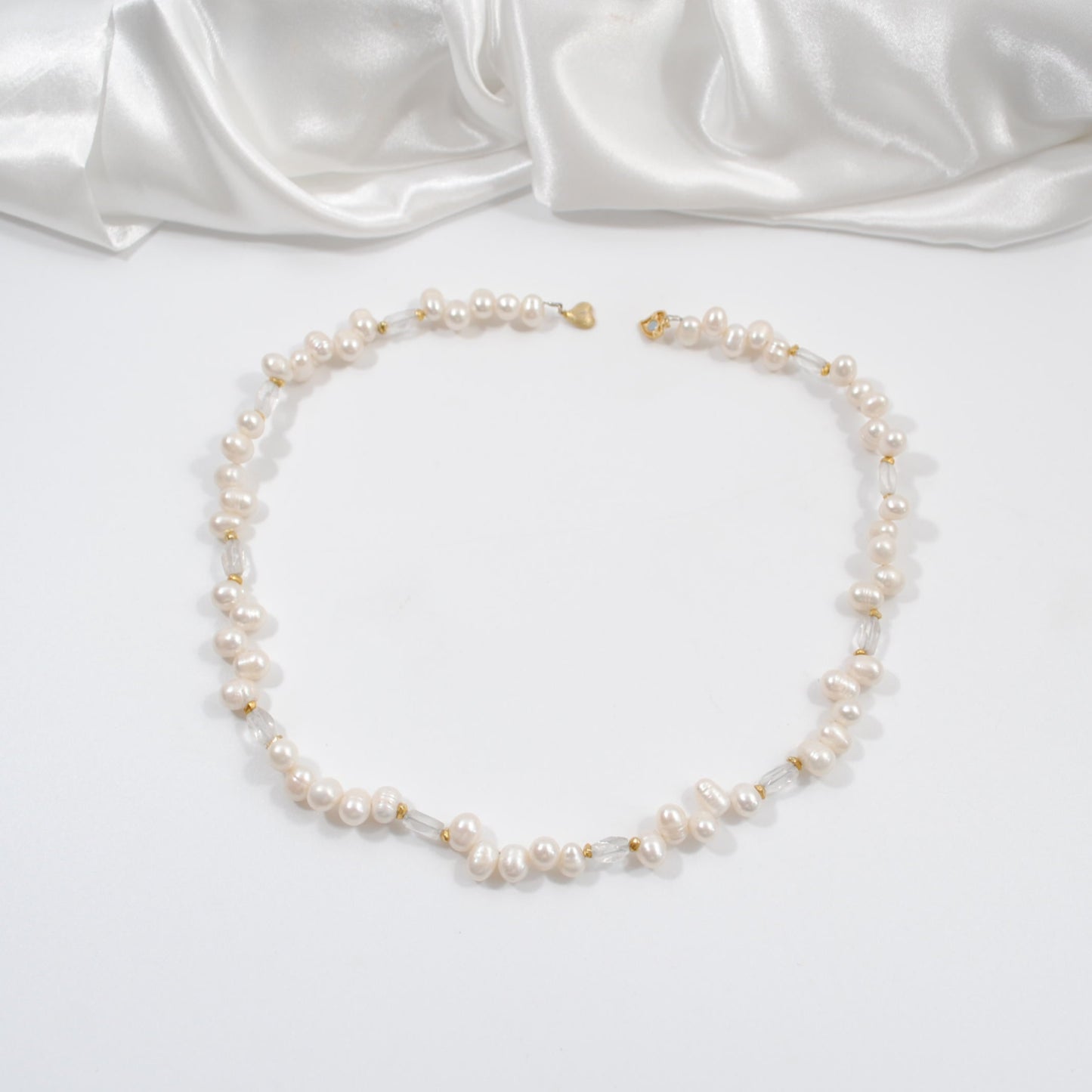 äkta svenskt hantverk kort halsband med vita sötvattens pärlor och sterling silver hjärtlås bergkristaller design by brandeby