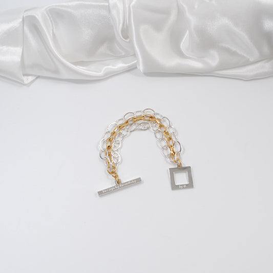 designat armband i två färger guld silver kedjor design by brandeby