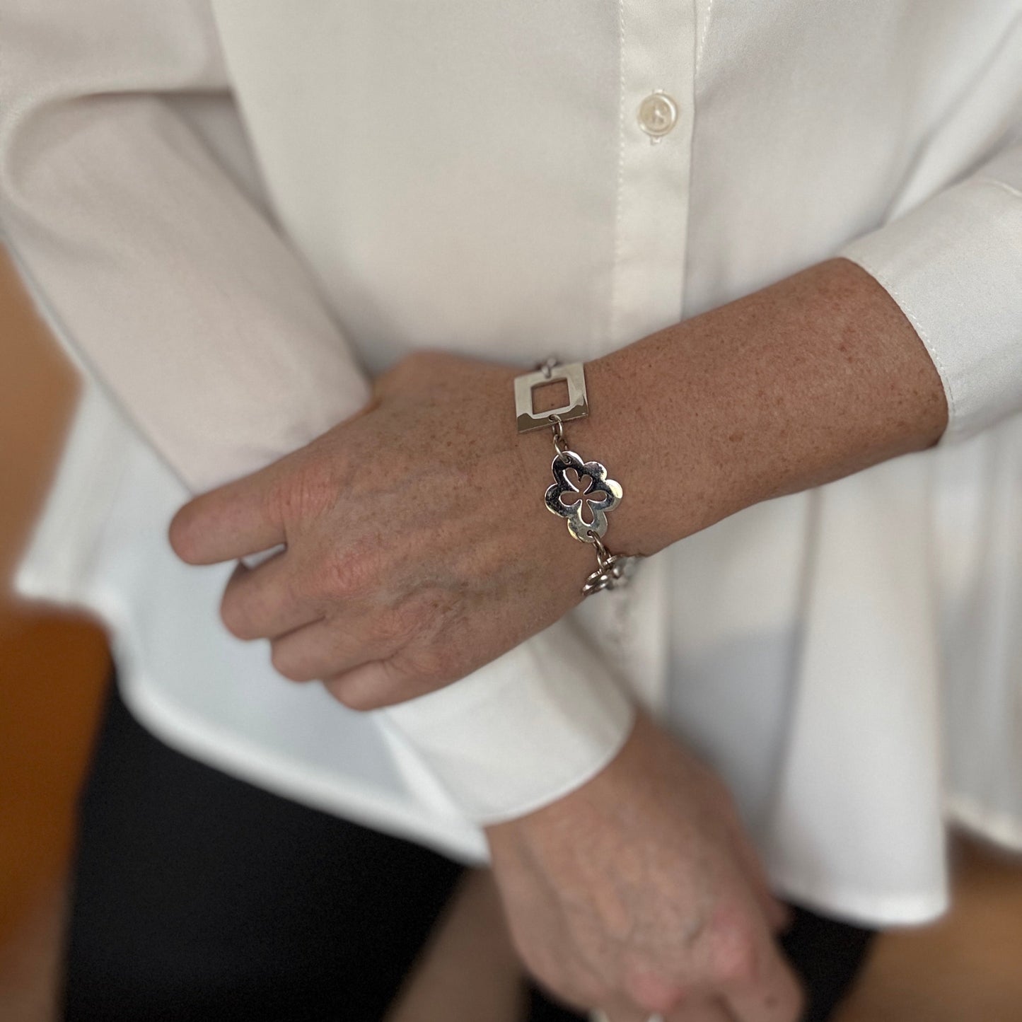 armband i silver med blommor och fyrkanter