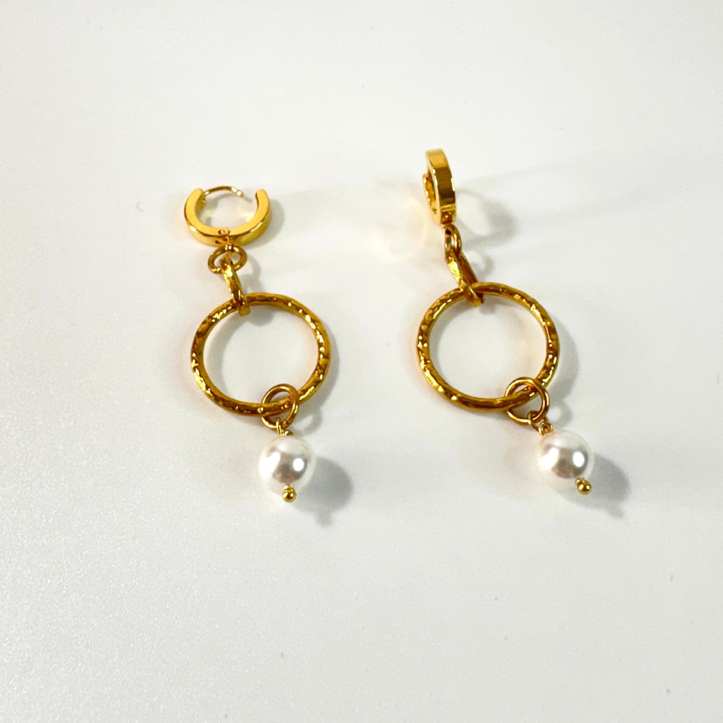 Eleganta guldörhängen med pärldetalj och hamrade ringar. Tidlös design från Design by Brandeby som passar både vardag och fest.
